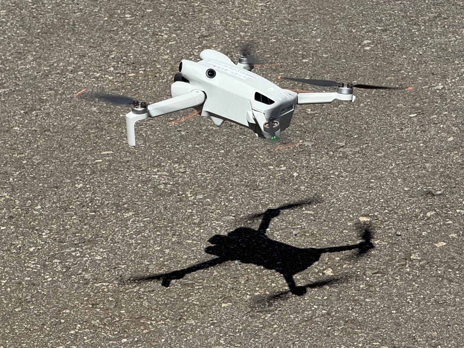 地面のすぐ上を飛行する小型のドローン